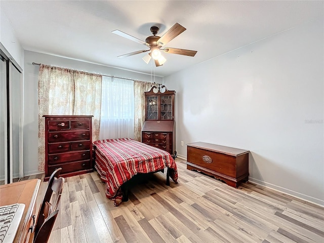 bedroom featuring light hardwood / wood-style flooring, a closet, and ceiling fan