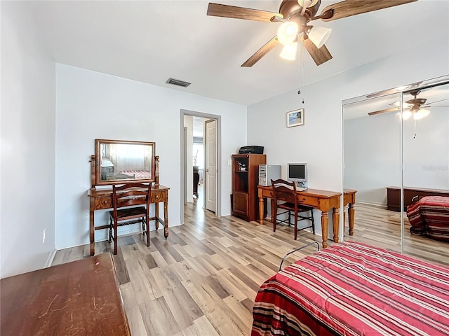 bedroom featuring ceiling fan, light wood-type flooring, and a closet