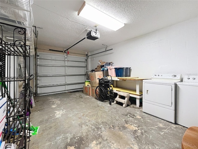 garage featuring a garage door opener and independent washer and dryer