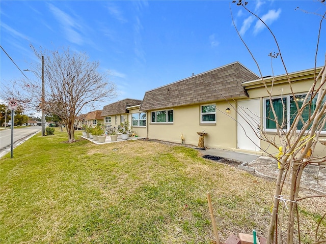 rear view of property with a patio and a lawn