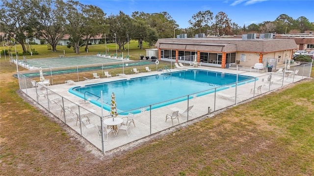 view of swimming pool with a yard and a patio area