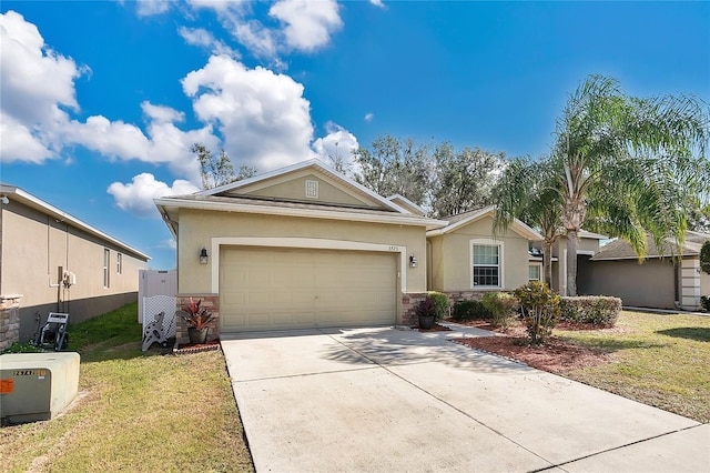 single story home featuring a garage and a front yard