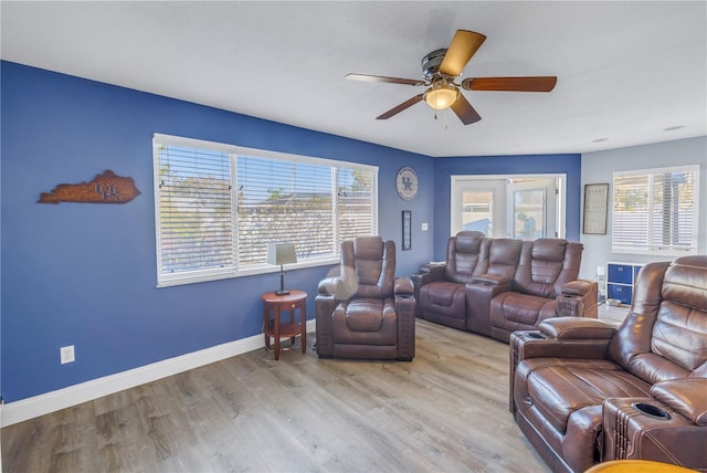 living room featuring ceiling fan, a healthy amount of sunlight, and light hardwood / wood-style flooring