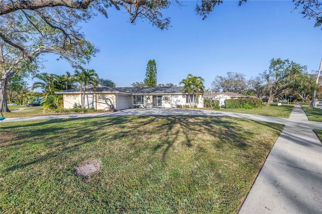 single story home featuring a garage and a front lawn