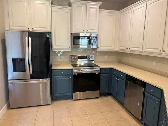 kitchen featuring white cabinetry, appliances with stainless steel finishes, tasteful backsplash, and light tile patterned floors