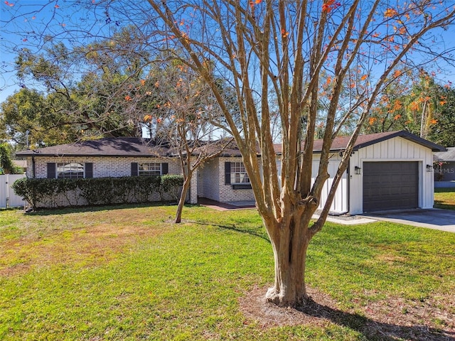 single story home featuring a garage and a front yard