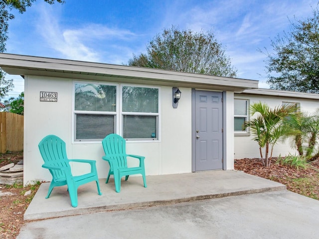 entrance to property featuring a patio