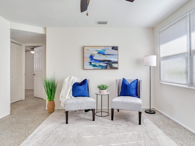 sitting room featuring ceiling fan