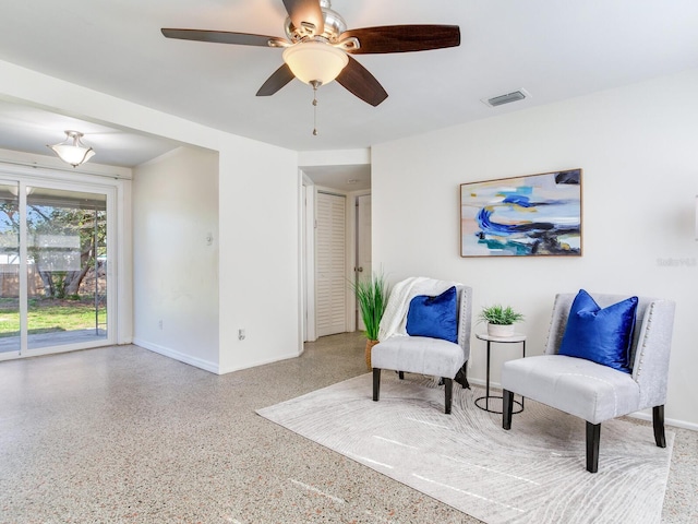 sitting room featuring ceiling fan