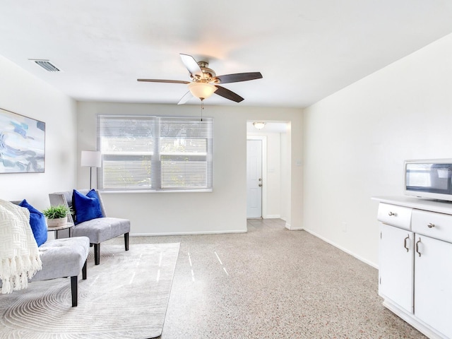 sitting room featuring ceiling fan