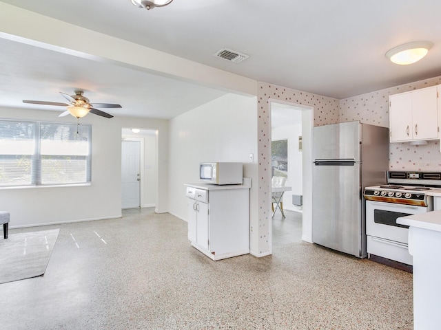 kitchen featuring ceiling fan, backsplash, white appliances, and white cabinets