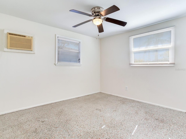 unfurnished room featuring ceiling fan and a wall unit AC