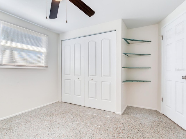 unfurnished bedroom with ceiling fan and a closet