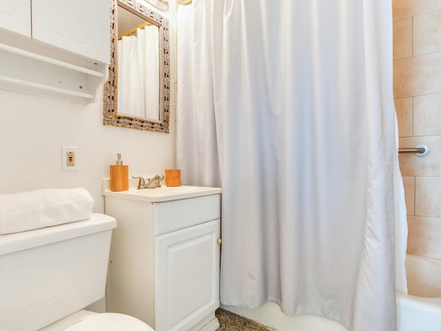 full bathroom with vanity, toilet, and shower / bath combo with shower curtain