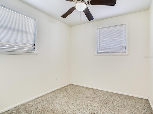 spare room featuring ceiling fan and carpet flooring