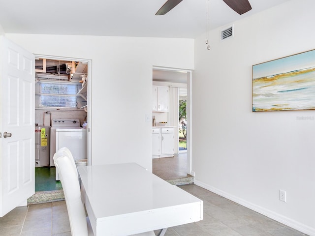 dining room featuring washer / clothes dryer, vaulted ceiling, electric water heater, and ceiling fan