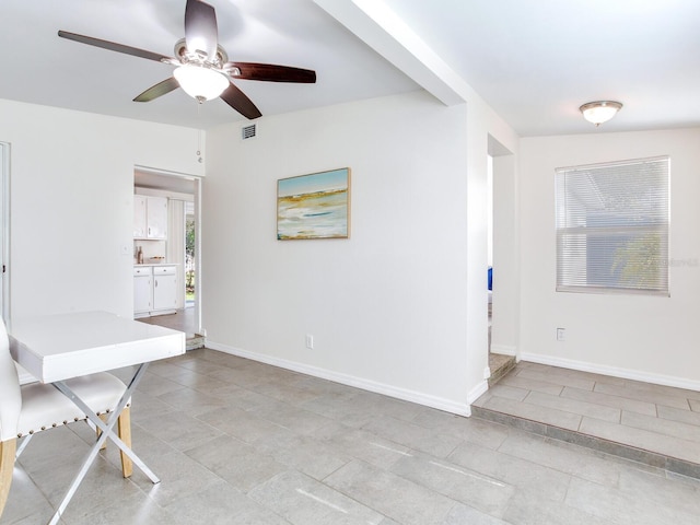 dining space with ceiling fan and light tile patterned floors