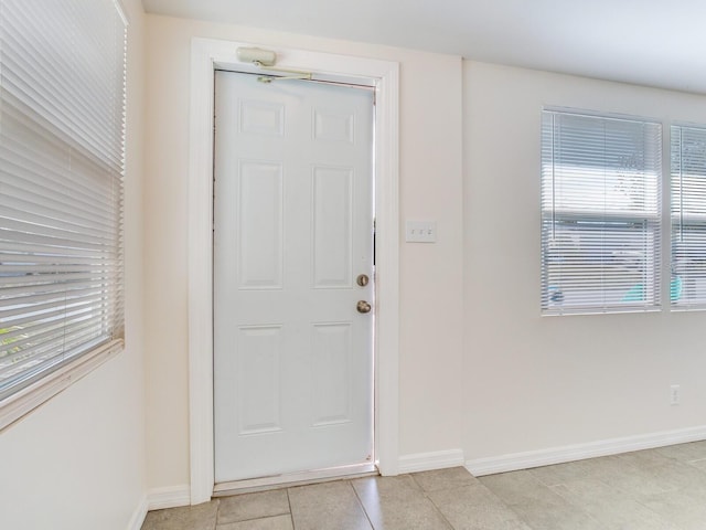 entryway with light tile patterned floors