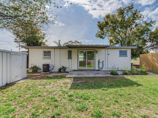 back of house featuring a patio area, a yard, and central air condition unit