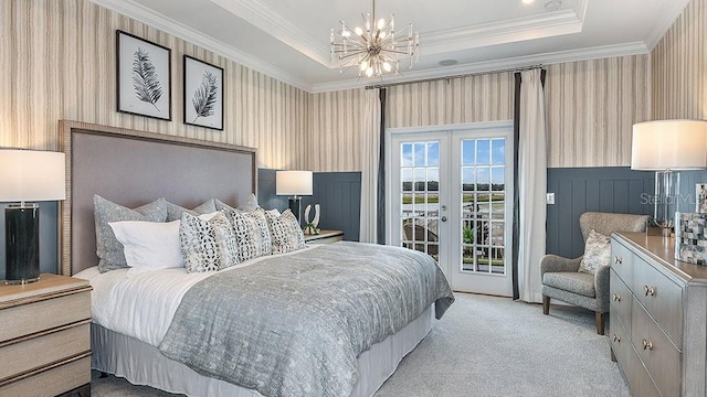 carpeted bedroom featuring crown molding, access to exterior, a tray ceiling, and french doors