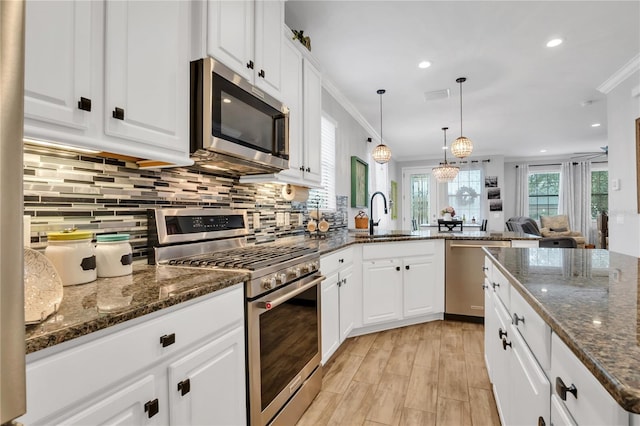 kitchen featuring sink, white cabinets, and appliances with stainless steel finishes