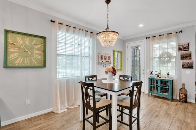 dining area with ornamental molding and a notable chandelier