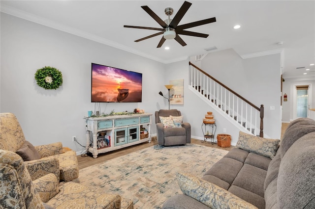 living room with crown molding, ceiling fan, and wood-type flooring