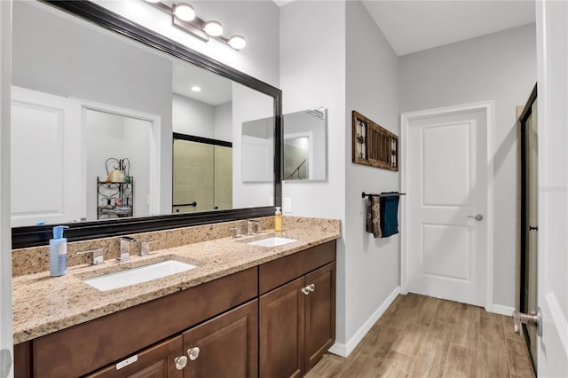 bathroom with vanity and a shower with shower door