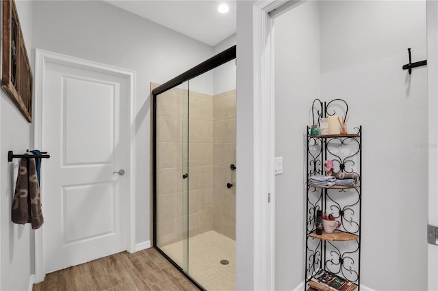 bathroom with a shower with door