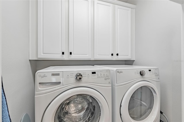 laundry room featuring cabinets and separate washer and dryer