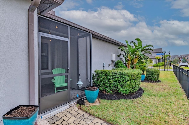 doorway to property featuring a lawn