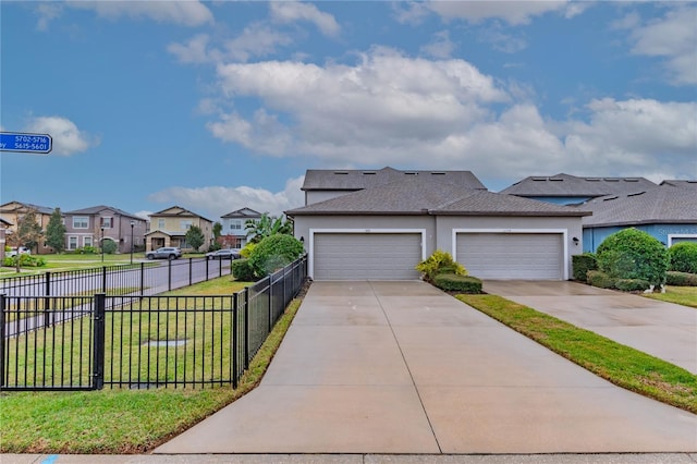 view of front of house with a garage and a front lawn