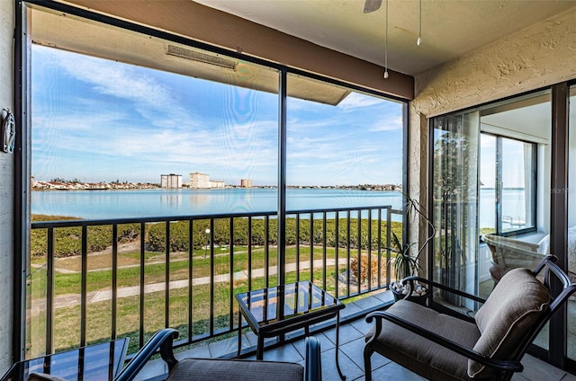 sunroom / solarium with a water view