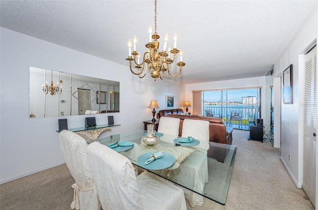 dining space featuring light colored carpet, a textured ceiling, and a notable chandelier