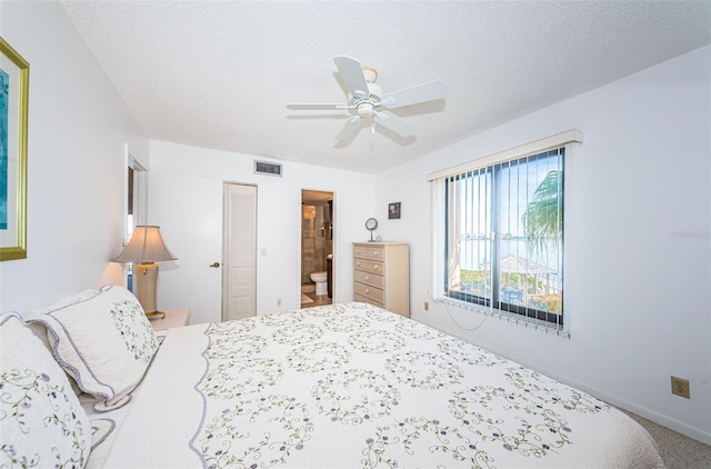 bedroom with connected bathroom, a textured ceiling, and ceiling fan