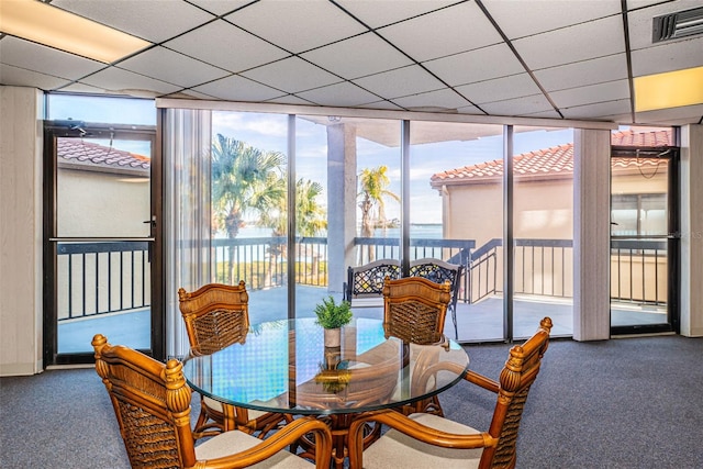 sunroom / solarium with a paneled ceiling