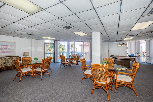 carpeted dining space featuring visible vents and a drop ceiling