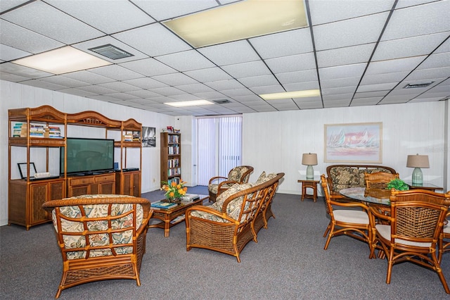 carpeted living area featuring a drop ceiling and visible vents