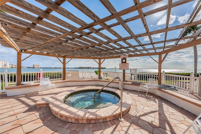 view of pool featuring a patio, a pergola, a water view, and a hot tub