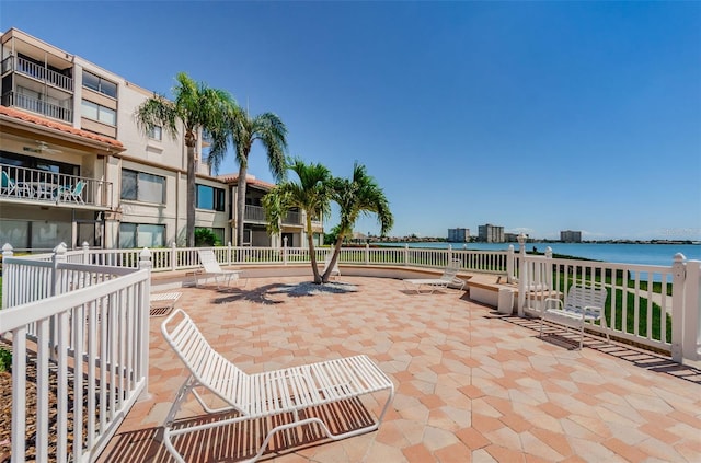 view of property's community featuring a water view and a patio