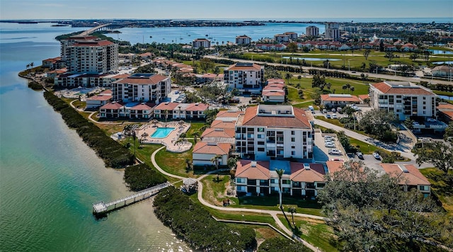 birds eye view of property with a water view and a view of city