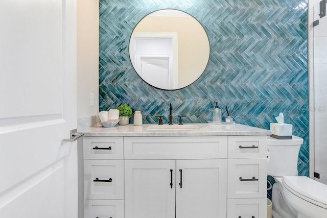 bathroom featuring vanity, tile walls, and toilet