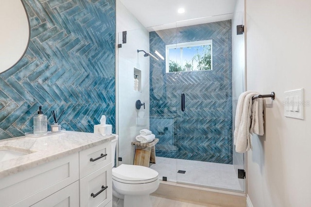 bathroom with vanity, an enclosed shower, and toilet