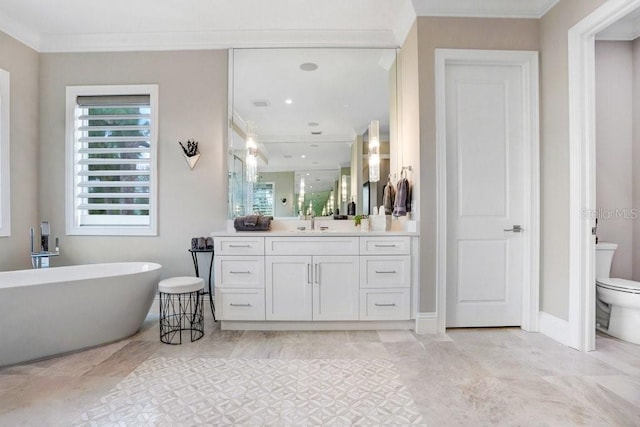 bathroom featuring ornamental molding, vanity, toilet, and a tub