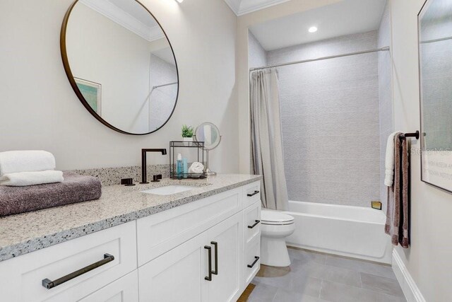 full bathroom featuring vanity, ornamental molding, shower / tub combo, and toilet