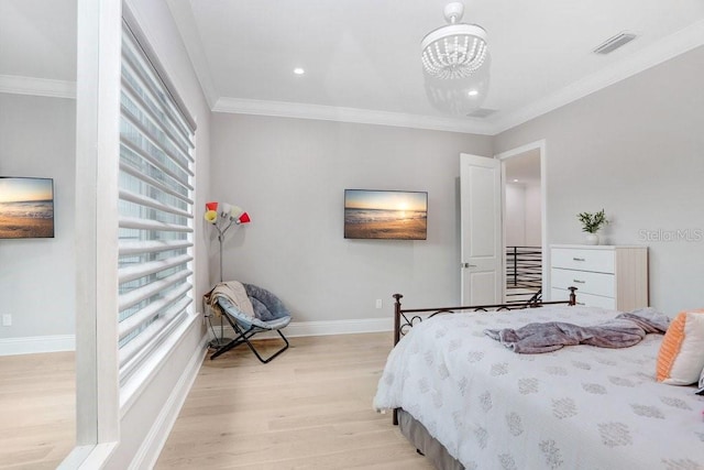 bedroom with crown molding, a chandelier, and light hardwood / wood-style floors