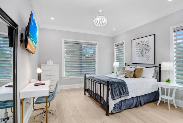 bedroom featuring crown molding, light hardwood / wood-style flooring, and a chandelier