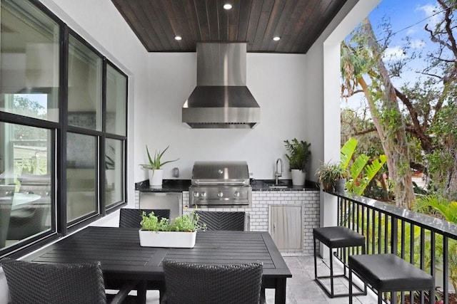 balcony featuring an outdoor kitchen, a grill, and sink