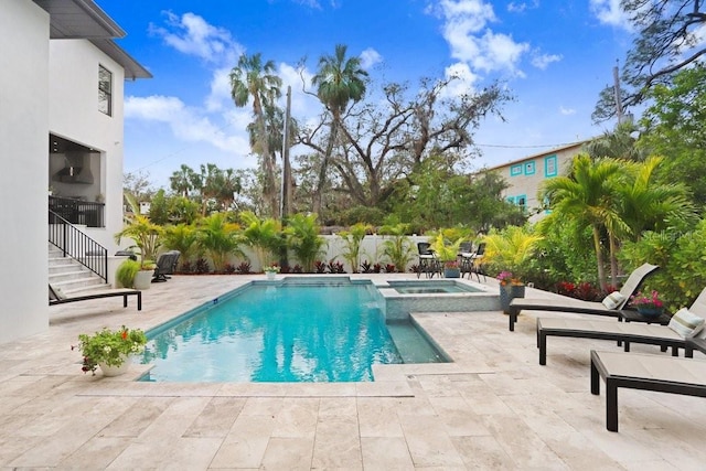 view of swimming pool with an in ground hot tub and a patio area