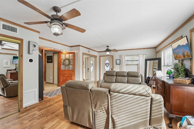 living room featuring crown molding, ceiling fan, and light hardwood / wood-style floors